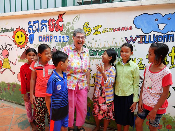 Maryknoll Sister Ann Sherman, above, is surrounded by students from her English class for underprivileged Cambodian children.