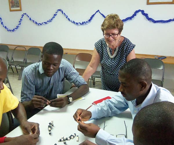 Affiliate Renate Schneider conducts a seminar to help Haitians solve local problems. Maryknoll Affiliates mark 25 years of mission.
