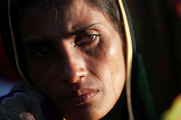 A Rohingya refugee who fled with her family from Myanmar cries after arriving at a camp in Bangladesh.