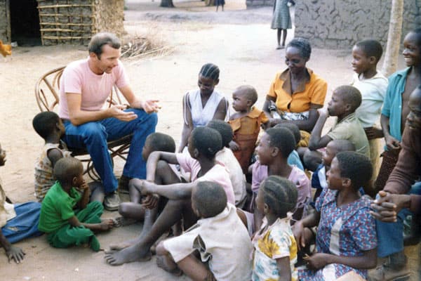 Father Michael Snyder, a Maryknoll missionary priest, engages with parishioners in Bunda, Musoma, Tanzania, when he was a young priest in 1983.