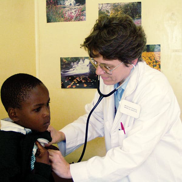 Medical missionary Susan Nagele, a doctor and Maryknoll lay missioner, examines a young Kenyan girl at her clinic. The missioner has spent more than three decades serving patients in Kenya, Tanzania and South Sudan.
