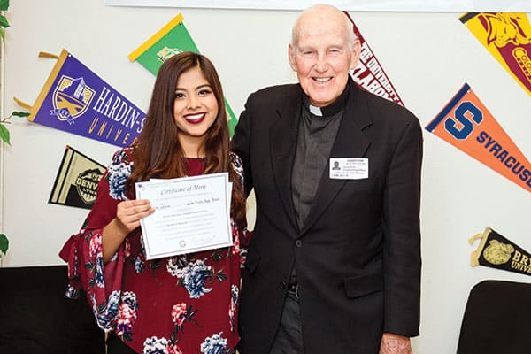 Tasnim Islam, a 12-grader at Lake Travis High School in Austin, Texas, joyfully accepts from Maryknoll Father Gerald Kelly the award for first place among essay winners 2017 in Division II.