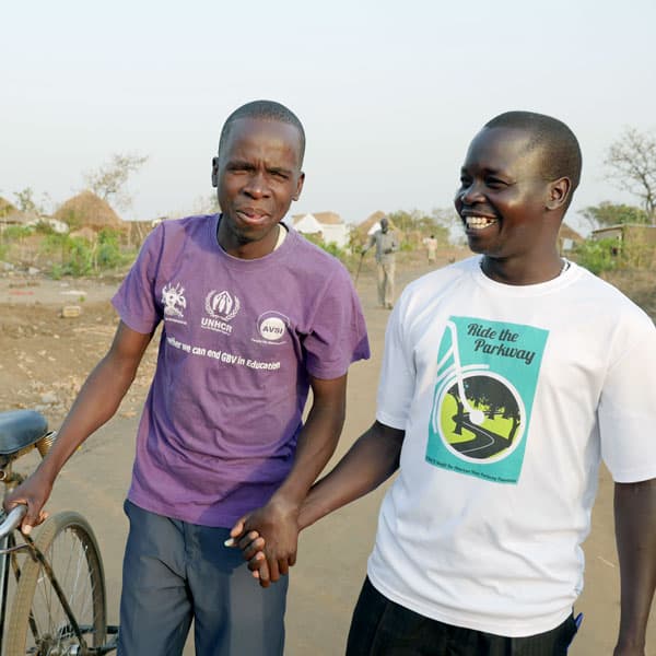Ocan Robert, a clan leader of the Acholi people of South Sudan, chats with friend at a refugee settlement in Uganda. Robert, a Catholic, advises fellow refugees to forgive and make peace.