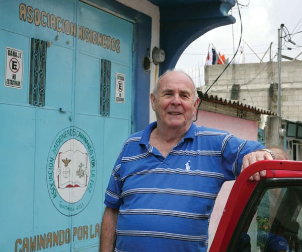 Ron Covey, a Maryknoll affiliate from Texas, stands outside the metal doors to Caminando Por La Paz (Walking Toward Peace) in Guatemala City.