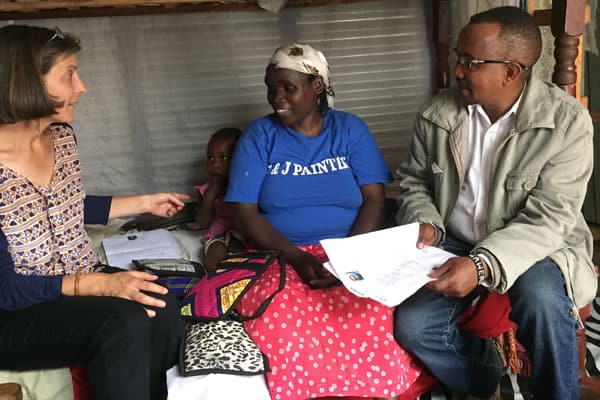 Maryknoll Lay Missioner Heidi Cerneka (left), whose work in Kenya involves helping imprisoned women, also makes time to work with refugees, such as the woman in the blue t-shirt. Cerneka was accompanied by Joseph Waweru, who worked for Jesuit Refugee Service.
