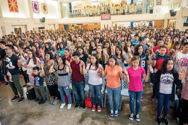 Migrant Filipino workers worship on Sunday in churches like Our Mother of Perpetual Help, a former movie theater where Maryknoll Father Joyalito Tajonera celebrates Mass in the Tagalog language.