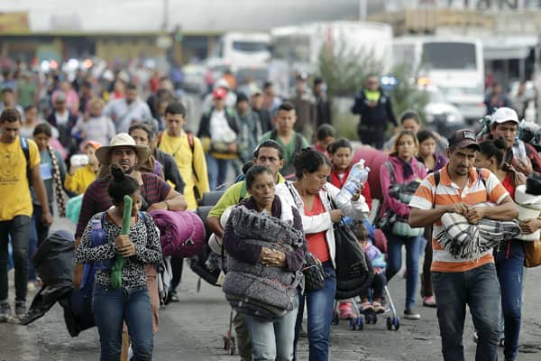 Former undocumented immigrant helps migrants today in Los Angeles: Migrants from Central America seeking asylum in the United States arrive in a caravan last November at the Church of the Assumption in Puebla, Mexico. (CNS/H. Rios, EPA)