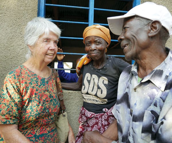 Sister Hughes confers with grandparents of pupils in Children Against AIDS program.
