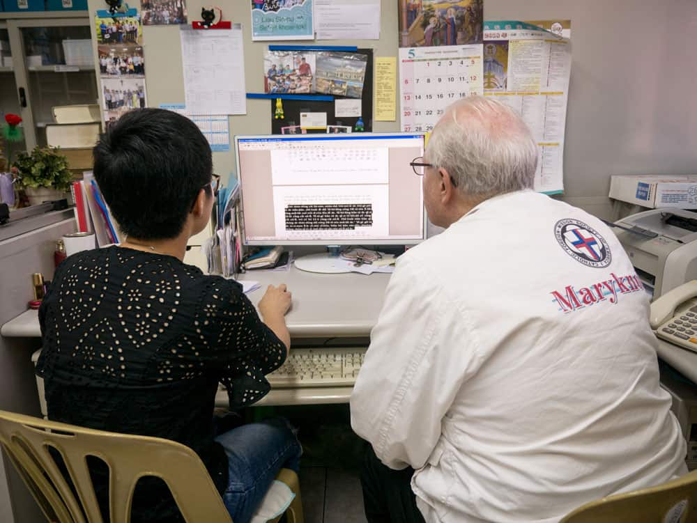 Father Anderson and Isabella Gao review translated texts at the Maryknoll Language Service Center in Taichung, Taiwan. (N. Sprague/Taiwan)
