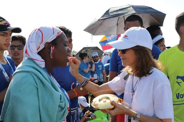 World Youth Day, 2019: A young pilgrim receives Communion during World Youth Day's closing Mass at Metro Park, renamed Field Saint John Paul II, in Panama. (M. Chin/Panama)