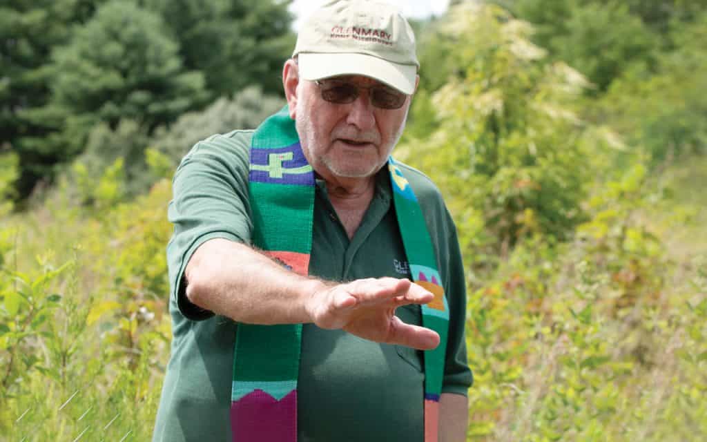 Glenmary Father John Rausch blesses new trees planted by pilgrims on an Appalachia immersion trip to eastern Kentucky, co-sponsored by the Glenmary Home Missioners and the Maryknoll Fathers and Brothers. Photo by O. Duran.