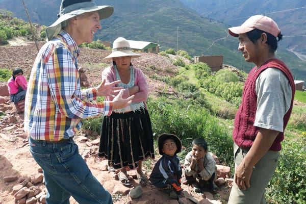 Maryknoll Lay Missioner Joseph Loney (left) talks with community leader Sebastian about helping the families in Sachacaymane repair the irrigation system. The missioners were in the village initially to help a widow with six children. (J. Siyumbu/Bolivia)