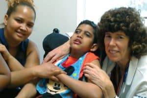 Dr. Ann Carr gives medical care to children with disabilities, like Omarlin, who has cerebral palsy, and listens to his mom, Amarilis. (Courtesy of M. Cejka/U.S.)