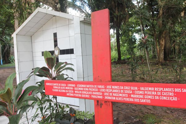 A red cross stands beside the grave of U.S.-born Sister Dorothy Stang in Anapu, Brazil, who was killed in 2005. The cross bears the names of 16 local rights activists who have been murdered since. (B. Fraser/Brazil)