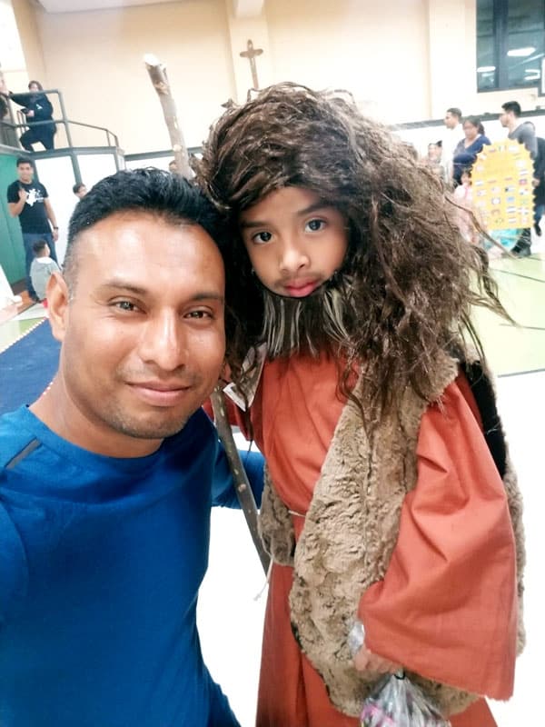 Young Hispanic Catholics: On the eve of All Saints' Day, young people organize an activity with games and dynamics for the children of the San Patricio community. In the photo, Germán Cruz with a child who represented San Juan Bautista in a dramatization they performed. (German Cruz / Rhode Island)