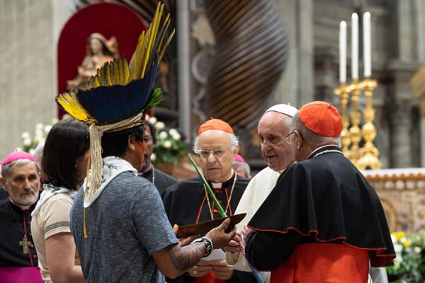 Pope Francis meets an indigenous man during a prayer service at the start of the first session Synod of Bishops for the Amazon at the Vatican Oct. 7, 2019. Some bishops say indigenous culture can enrich Catholic liturgy.(CNS/Vatican Media)