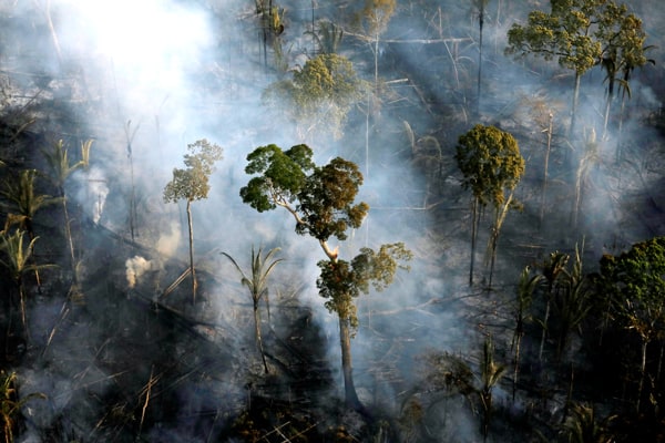 Smoke billows during a fire in an area of the Amazon rainforest near Porto Velho, Brazil. The Amazon Synod at the Vatican in October considered the environmental impact on the Amazon forest and its people. (CNS/Bruno Kelly, Reuters/Brazil)