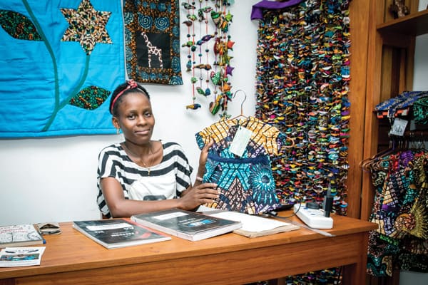 Beatrice shows the products made by people at Uzima Centre at the Vipaji Vyetu store in Mwanza. The store also sells crafts from other church-based charitable organizations. (J. Fleury/Tanzania)