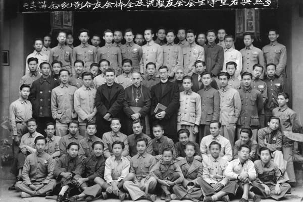 Maryknoll Bishop Francis X. Ford with students and teachers of Kaying Newman Hall, a hostel for Catholic high school students in Kaying (Meixian), China, circa 1940. (Maryknoll Mission Archives)