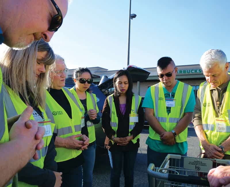 MercyWatch volunteers in Everett, Wash., stop to pray together before they work with the homeless. (Peter Saunders/U.S.)