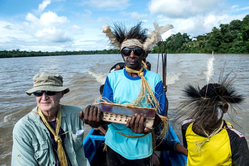 After baptism in the jungle, Asmat villagers accompany Father Cole on the boat trip to his home in the village of Er. Photo by Joshua Irwandi/Indonesia