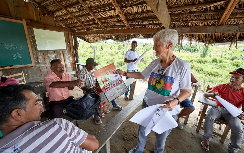 U.S. Sister Kathryn "Katy" Webster, a member of the Sisters of Notre Dame de Namur from the United States, hands out a calendar that promotes the Synod of Bishops on the Amazon to farmers in the countryside near Anapu, in Brazil's northern Para state, in this April 2019 file photo. (CNS photo/Paul Jeffrey)