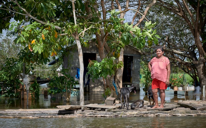 Juscelina Silva Batista, 54, stands in front of her house in the middle of the Amazon River near Santarem, Brazil, April 11, 2019. The Vatican released Pope Francis' postsynodal apostolic exhortation, "Querida Amazonia" (Beloved Amazonia), Feb. 12, 2020. (CNS Photo/Paul Jeffrey)