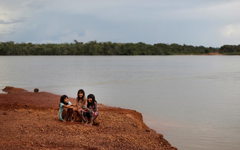 Indigenous children sit on the banks of the Xingu River in Brazil's Xingu Indigenous Park Jan. 15, 2020. (CNS photo/Ricardo Moraes, Reuters)