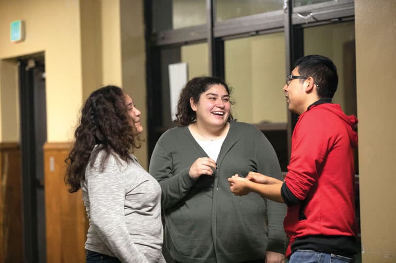 Fatima Carrillo (center), a leader of Peace Warriors, talks with teenagers on a Friday. (Octavio Durán / Illinois)