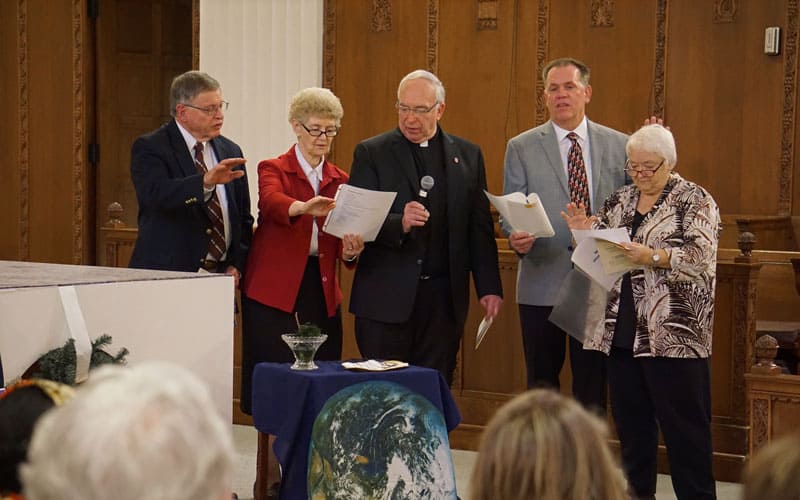 Leaders of the four Maryknoll entities participate in the sending of five new Maryknoll missioners in December 2019. Pictured, from left, are Bob Short of the Maryknoll Affiliates, Sister Antoinette Gutzler of the Maryknoll Sisters, Father Raymond J. Finch of the Maryknoll Fathers and Brothers, and Ted Miles and Marj Humphrey of the Maryknoll Lay Missioners. (Meinrad Scherer-Emunds/U.S.)