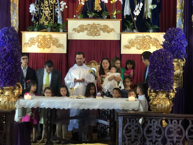 Maryknoll Father Rodrigo Ulloa celebrates a baptism in Guatemala City, in Guatemala, the country he was visiting when the Guatemalan government decided to close its borders due to the COVID-19 pandemic.