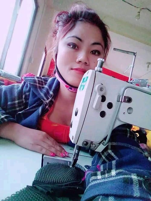A young woman who graduated from the Sewing and Cutting Training Program for Persons with Disabilities in Nepal works at her sewing machine. The graduates are using their skills to make face masks in their villages during the COVID-19 pandemic. (Courtesy of Joseph Thaler/Nepal)