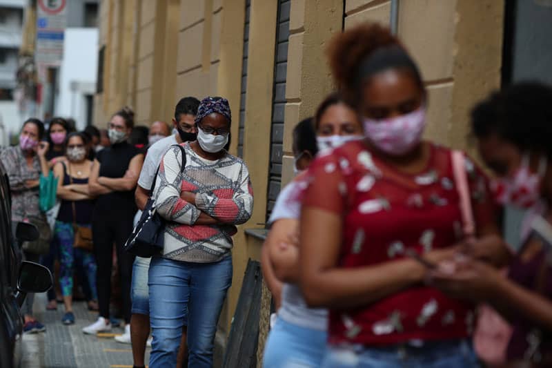 People wait in line to enter a shop in Sao Paulo June 10, 2020, during the COVID-19 pandemic. (CNS photo/Amanda Perobelli, Reuters)
