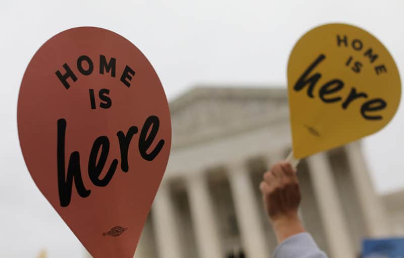 DACA demonstrators hold signs outside the U.S. Supreme Court in Washington Nov. 12, 2019. In a 5-4 decision June 18, 2020, the Supreme Court rejected President Donald Trump's executive order to cancel the Deferred Action for Childhood Arrivals program, which provides legal protections and work authorization to immigrants brought to the U.S. as children by their parents without legal documents. (CNS photo/Jonathan Ernst, Reuters)