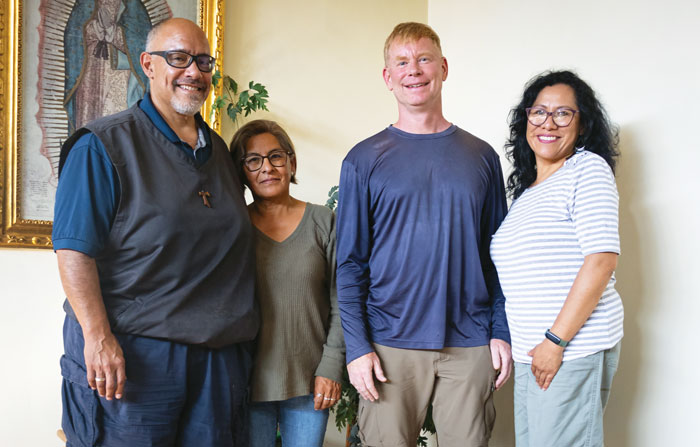Victor Artaiz, Rosse Mary Miranda, Father McPhee and Mabel Ramírez (left to right) hold a meeting at the Maryknoll center and residence in Cochabamba. (Adam Mitchell/Bolivia)