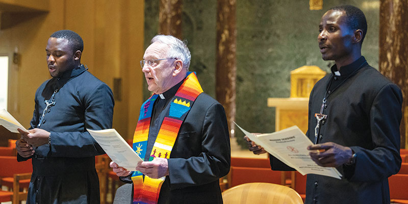 Fathers Maondo and Ogony, wearing their mission crosses, sing with Maryknoll Superior General Lance Nadeau during the sending ceremony held later that day. (Octavio Durán/U.S.)